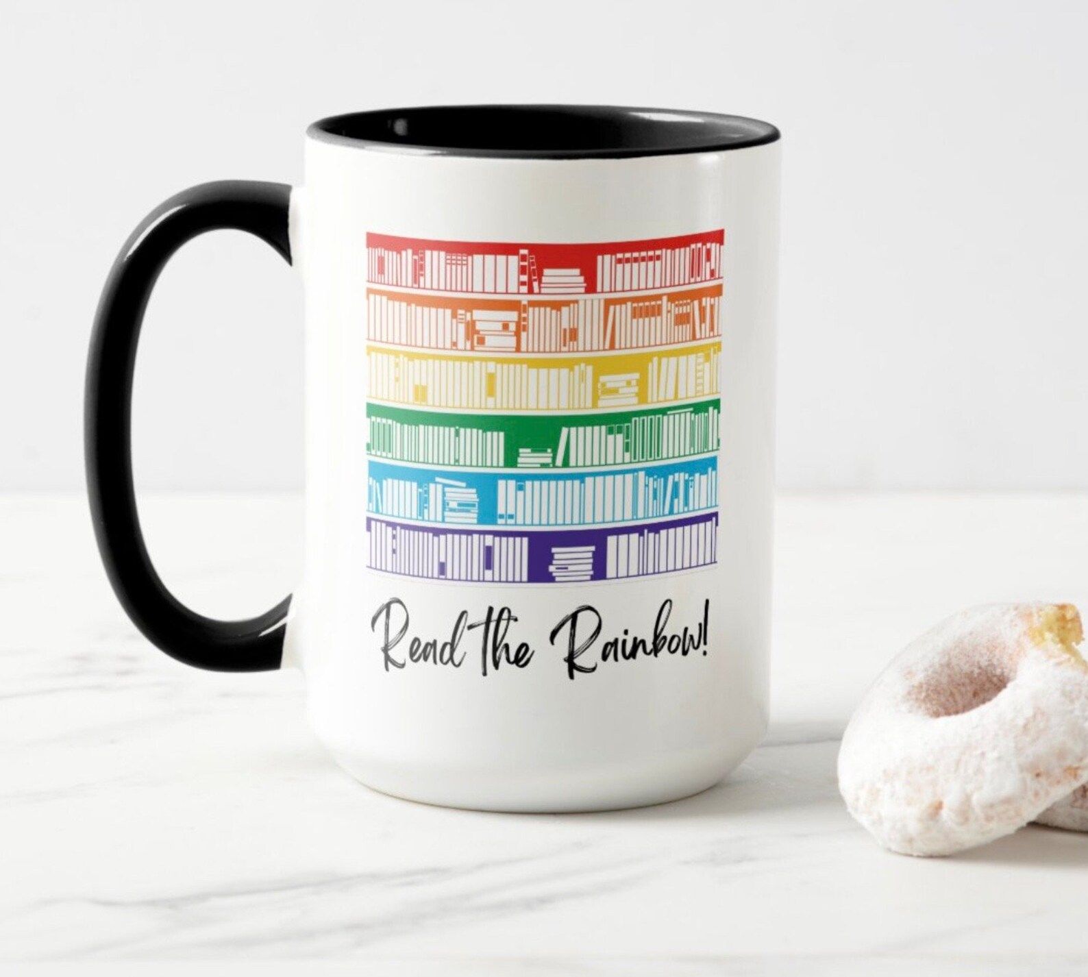 rainbow bookshelves on a mug with the text "read the rainbow."