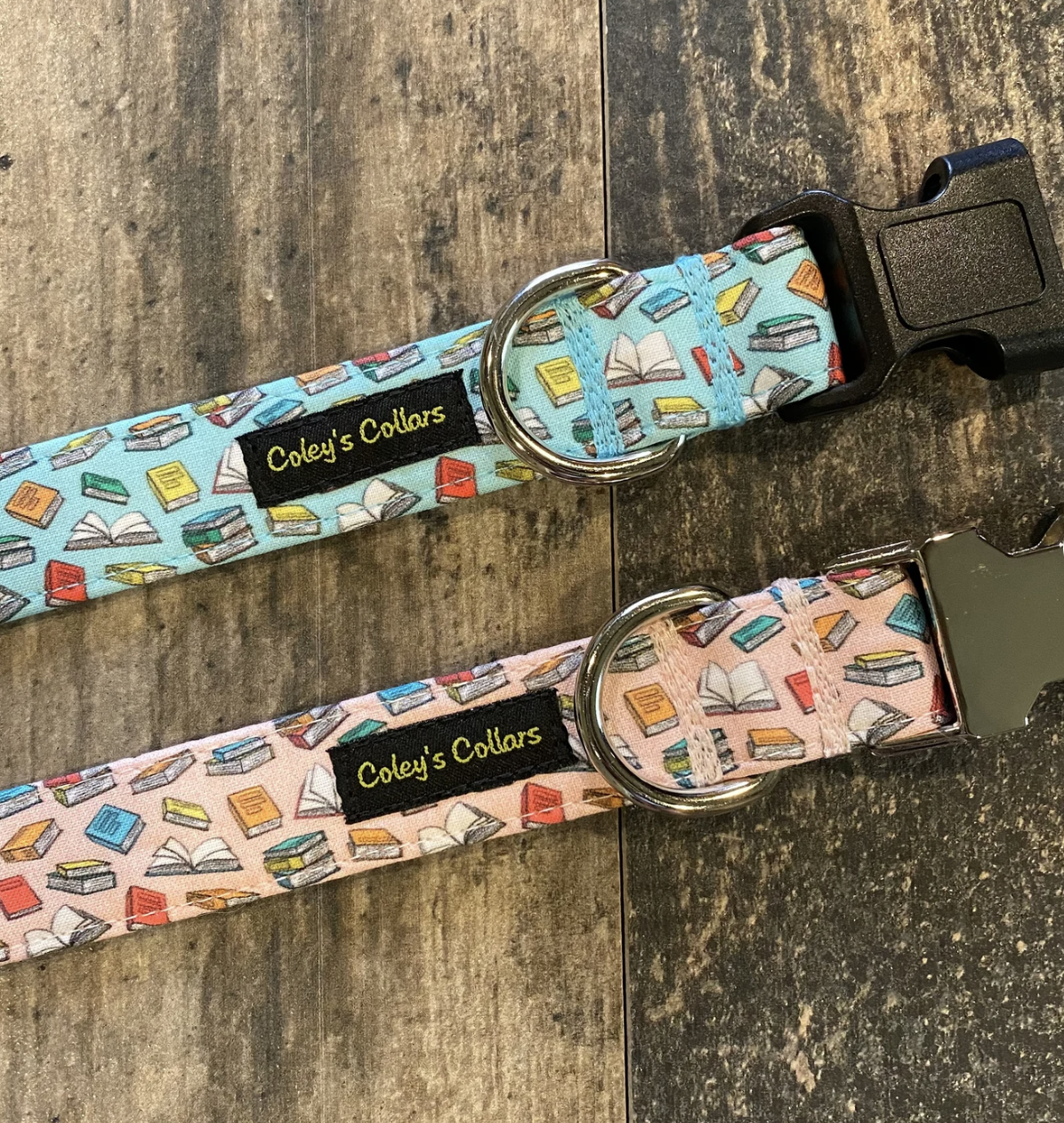 Two fabric dog collars with tiny cartoon book prints, one light pink and one light blue