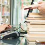 a photo of a stack of books being bought