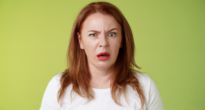 a photo of a white woman with red hair making a horrified or disgusted expression