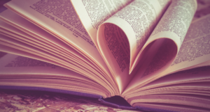 a photo of a hardcover book with pages folded toward the center to make a heart