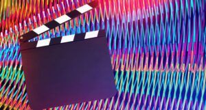 Image of a clapboard with a colorful background