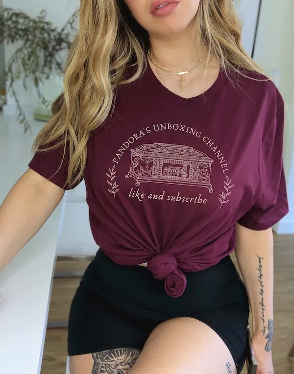 burgundy tshirt with text that reads "Pandora's Unboxing Channel, like and subscribe" around an image of an ornate box