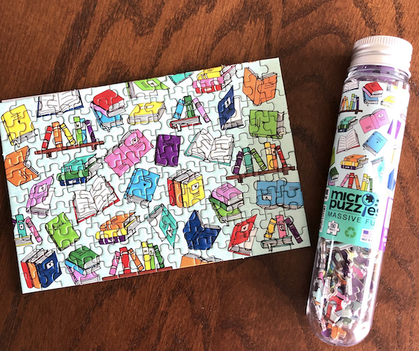 micro jigsaw puzzle with an illustration of colorful books on a white background