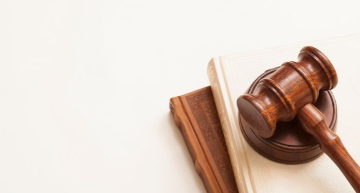 a brown gavel against a cream colored background