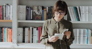 a woman browsing books at a bookstore