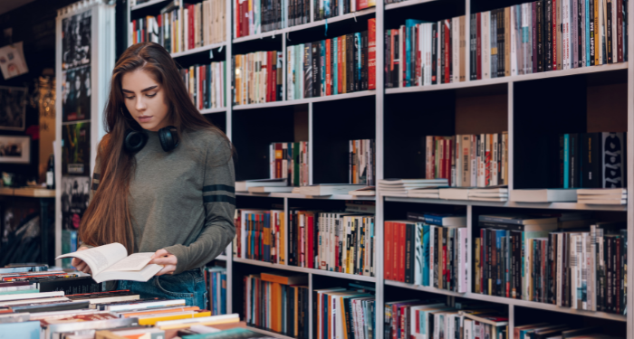 a photo of a woman browsing at a bookstore