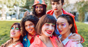 a group of queer friends all wearing glittery makeup