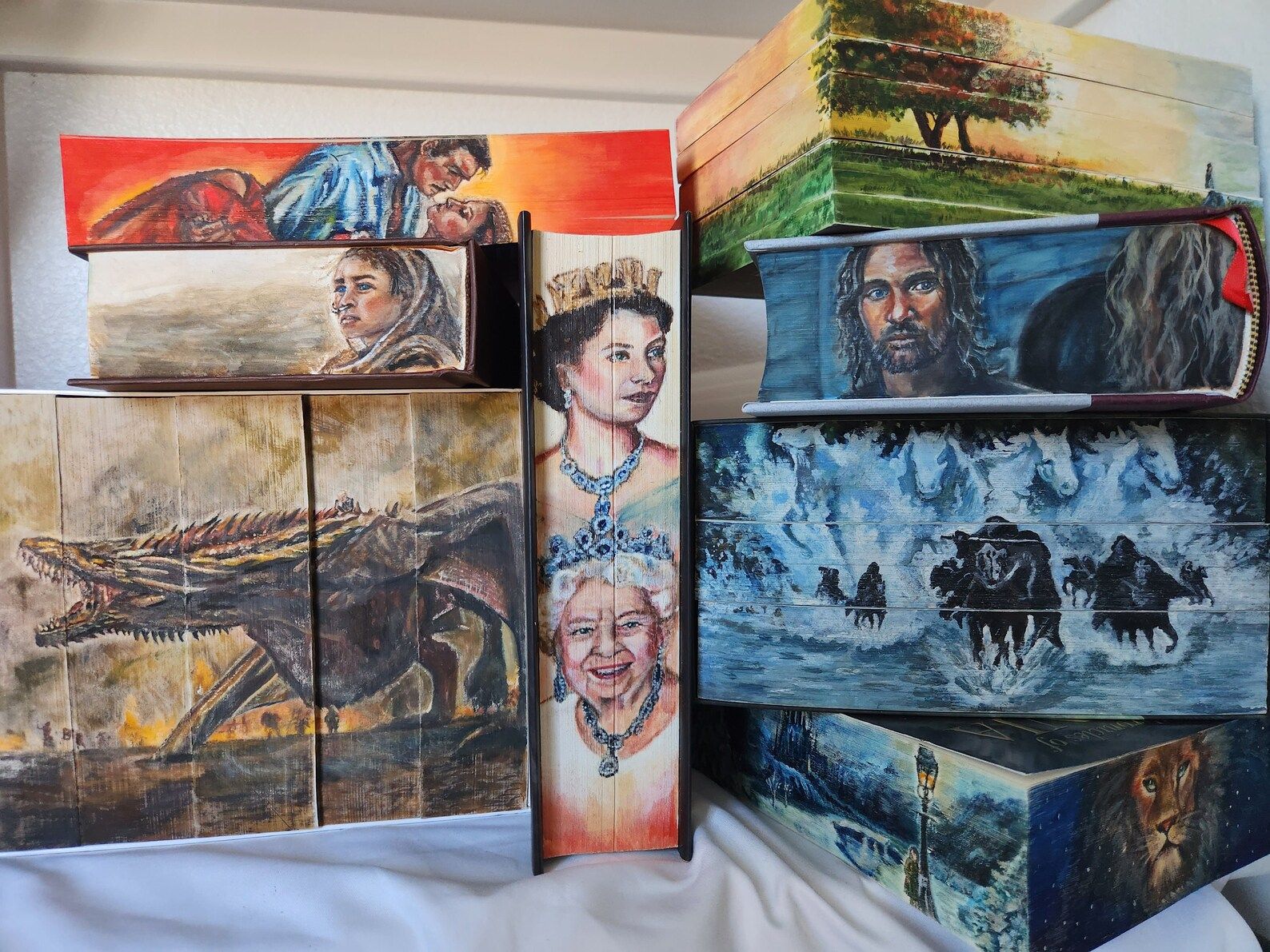 picture of multiple hand painted book edges done by whitneybookpaintings