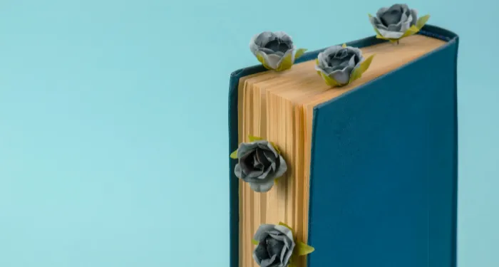 a photo of a book with flowers sticking out between the pages