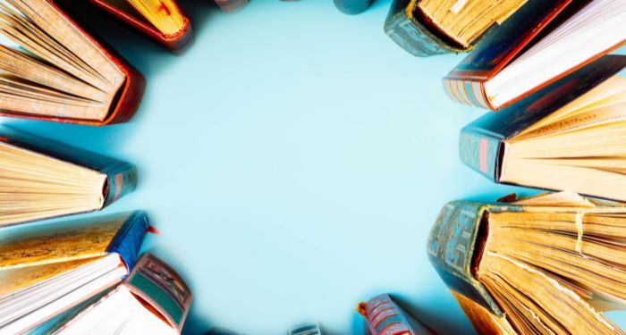 books arranged upright in a circle with a blue background