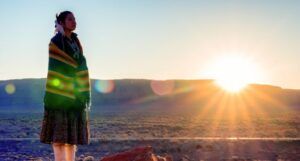 Image of a Navajo Native girl in front of a sunrise