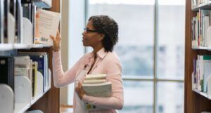 Image of a Black librarian at a bookshelf