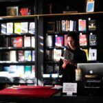 a photo of a woman behind the desk of a bookstore