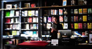 a photo of a woman behind the desk of a bookstore