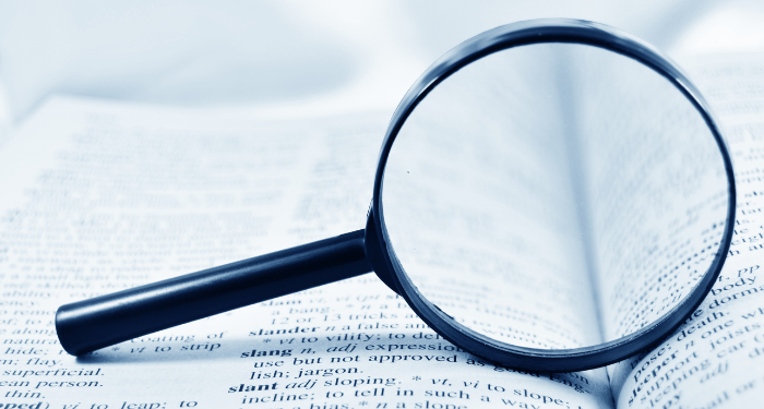 a photo of a dictionary with a magnifying glass