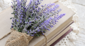 a photo of books with a bundle of lavender on top
