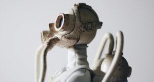 a closeup photo of a robot toy wearing a gas mask