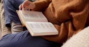 a book of poetry open and resting on a person's lap