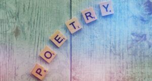 Scrabble letters spelling out the word "poetry."