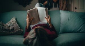 woman reading upside down on couch