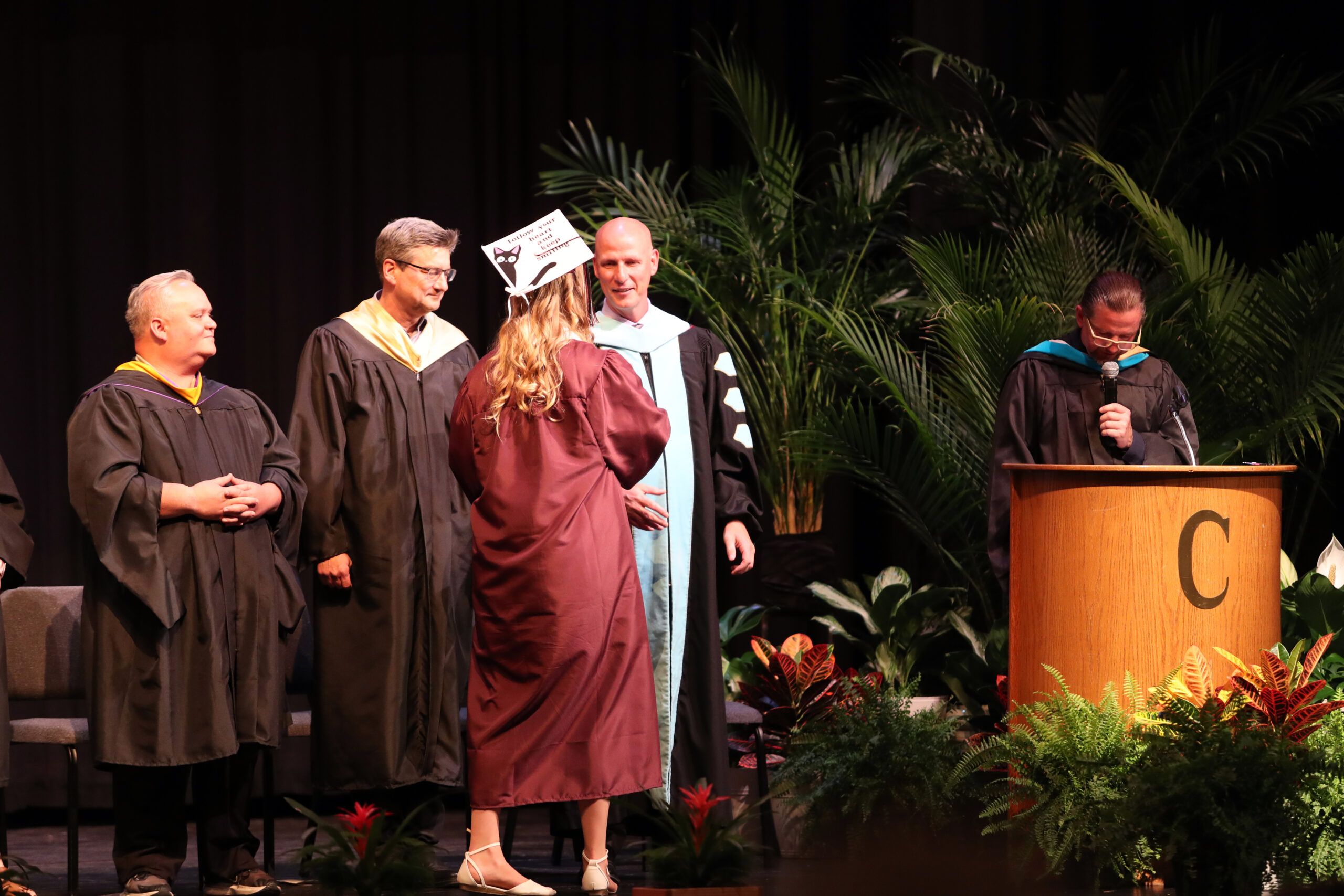 Image of Annabelle handing Dr. bub The Handmaid's Tale. 