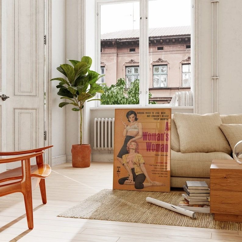 a framed posted of the lesbian pulp cover A Woman's Woman