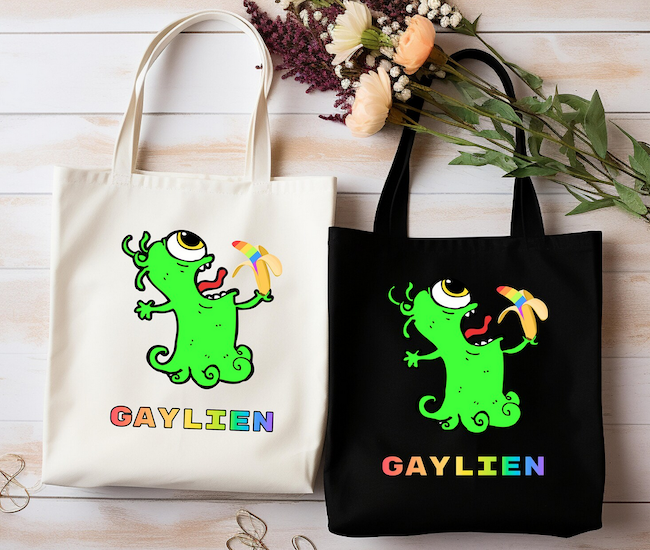 a tote bag with a graphic illustration of an alien eating a rainbow colored banana and text saying gaylien