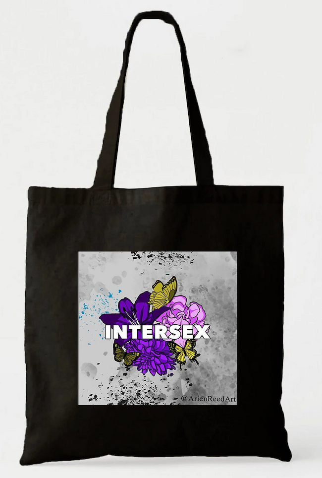 Black Tote featuring drawing of flowers and butterflies in pride flag colors with text saying Intersex