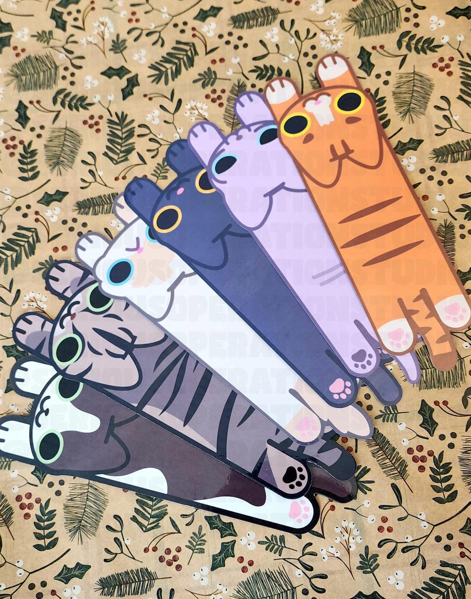 a photo of cartoon cat bookmarks all laid out in a row