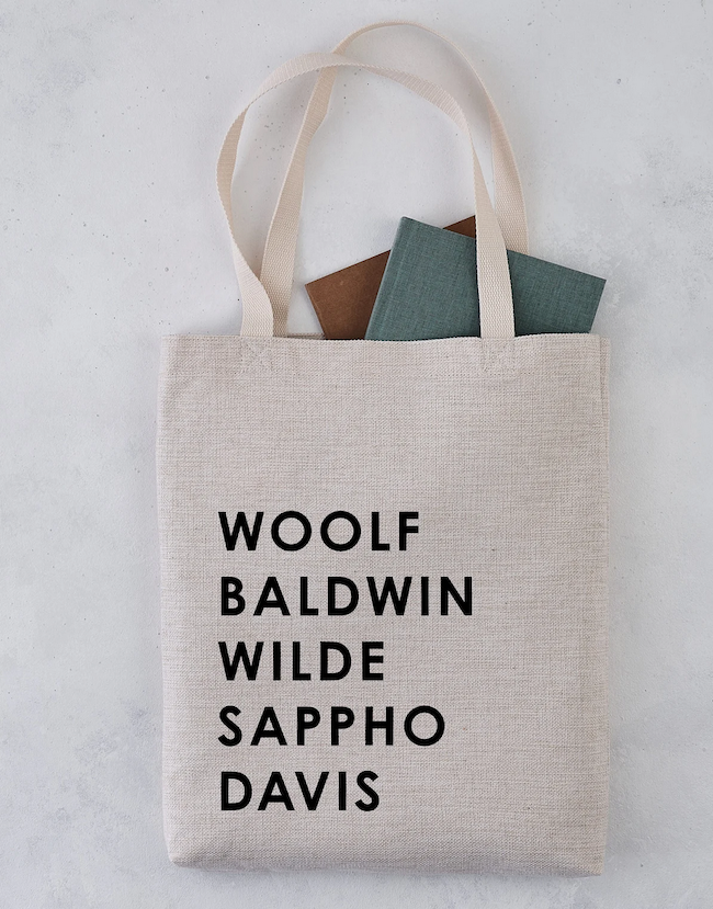 a tote bag with authors last name stacked in black font: Woolf, Baldwin, Wilde, Sappho, Davis