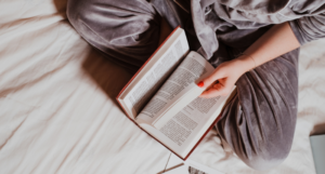 a photo of a person reading in bed