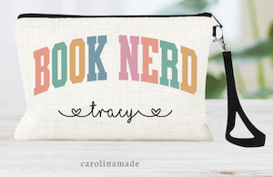 a wristlet bag with book nerd in bold colorful font and a name personalized below