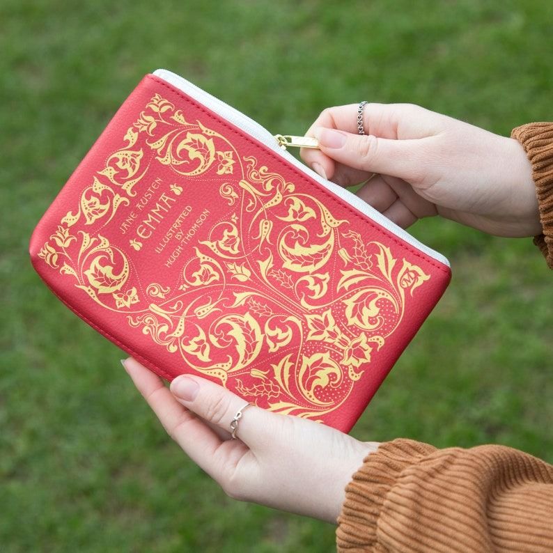 a red zip-up pouch that looks like a cover of Emma