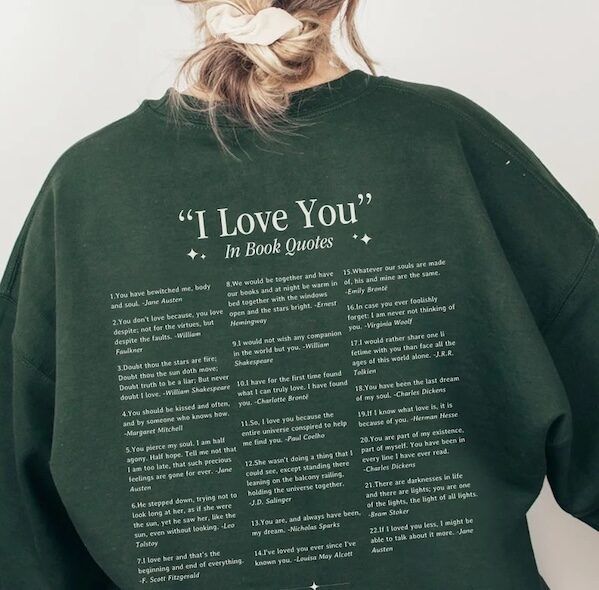 back of a green crewneck sweater. the words "I Love You in Book Quotes" are at the top of the sweater, followed by 22 book quotes in three columns