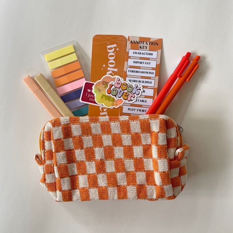 a checkered book pouch filled with annotation materials