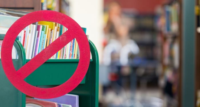 books on a library cart with a red x through it