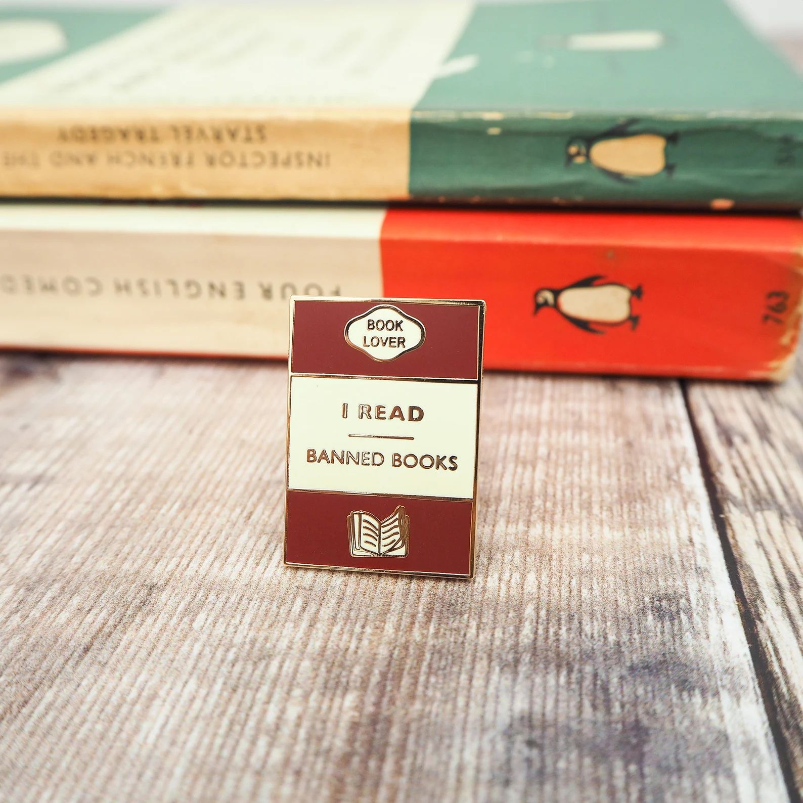 a photo of an enamel pin that says "Read Banned Books"