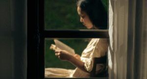 light tan-skinned Asian woman reading outside