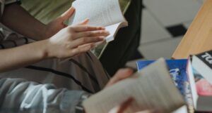 people holding books open