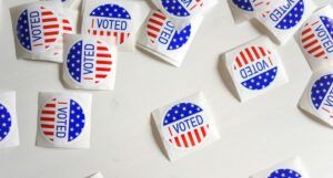 scattered I Voted stickers with American flag design