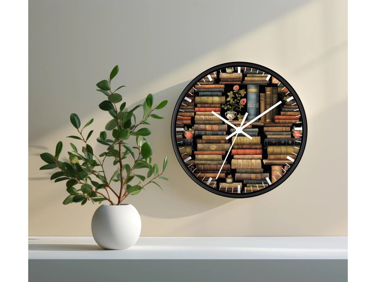 Wall clock with book stacks on it hanging on a white wall next to a green plant.