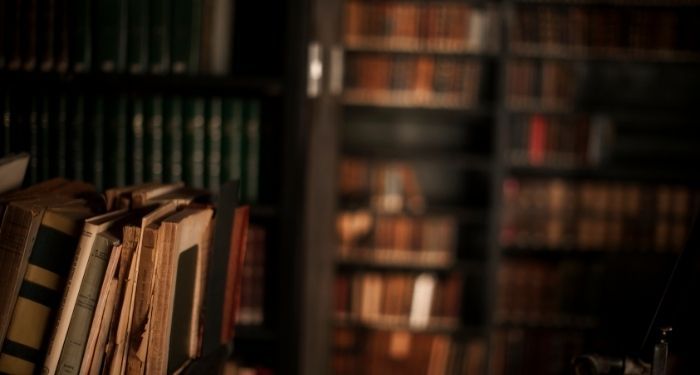 dark and unsettling image of book stacks in a library.