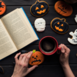 an open book surrounded by Halloween cookies