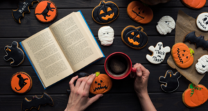 an open book surrounded by Halloween cookies