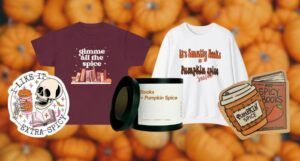 selection of pumpkin-spice themed bookish gifts, including stickers, apparel, and a candle