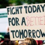 cardboard protest sign that reads, fight today for a better tomorrow