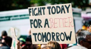 cardboard protest sign that reads, fight today for a better tomorrow