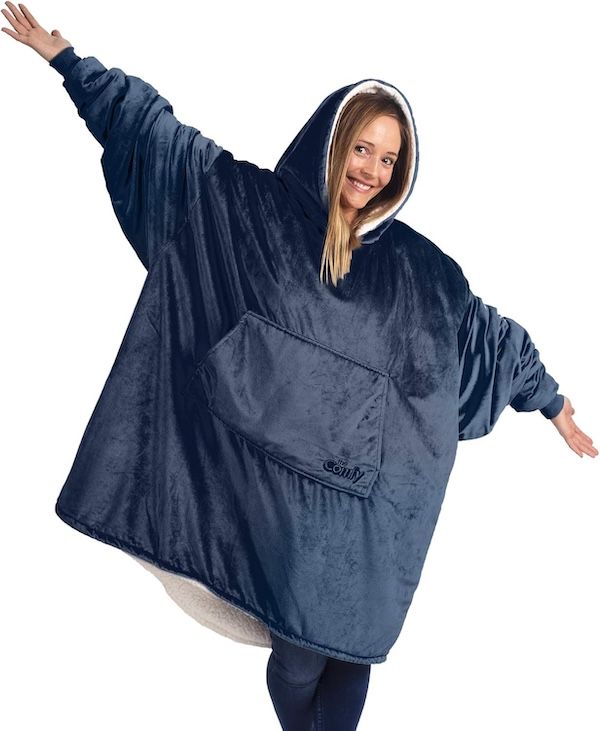 woman with arms extended wearing a blue hooded fleece-lined wearable blanket