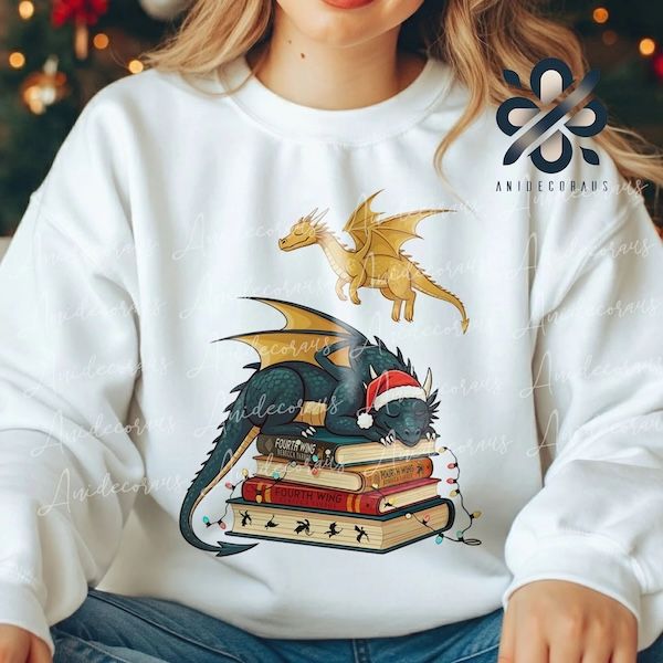 a white woman wearing a white crewneck sweater with a graphic of a dragon in a Santa hat sleeping on a pile of books plus another dragon flying overhead